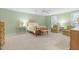 Comfortable bedroom featuring neutral walls and carpet, well-lit with bright windows, and two sitting chairs at 103 Bruce Dr, Cary, NC 27511