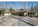 Home exterior featuring a beautiful brick driveway, attached garage, and lovely landscaping at 103 Bruce Dr, Cary, NC 27511