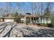 Charming home featuring a brick driveway, attached garage, and cozy front porch at 103 Bruce Dr, Cary, NC 27511