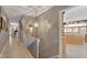 Hallway view with tile flooring and a glimpse into a kitchen with granite countertops and natural light at 103 Bruce Dr, Cary, NC 27511