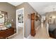 Inviting hallway with a grandfather clock, neutral paint and a glimpse into a shelved room at 103 Bruce Dr, Cary, NC 27511