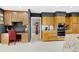 Bright kitchen featuring custom cabinetry, built-in appliances, a desk area, and light tile flooring at 103 Bruce Dr, Cary, NC 27511