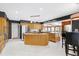 Open kitchen design with a large island, stainless steel refrigerator, and views into the Gathering room at 103 Bruce Dr, Cary, NC 27511