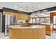 Well-lit kitchen boasts granite counters, wood cabinets, modern appliances, and a functional center island at 103 Bruce Dr, Cary, NC 27511