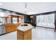 Eat-in kitchen space with wood cabinets, granite countertops, and an island with a cooktop at 103 Bruce Dr, Cary, NC 27511