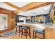 Kitchen with granite countertops, wood paneling, and a breakfast bar at 103 Bruce Dr, Cary, NC 27511