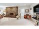 Living room boasting a stone fireplace, a ceiling light, an area rug, and a mounted TV at 103 Bruce Dr, Cary, NC 27511