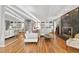Bright living room features hardwood floors, a fireplace, built-in storage and mirrored wall at 103 Bruce Dr, Cary, NC 27511