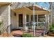 Charming covered patio with outdoor furniture, awning, and a view of the surrounding trees at 103 Bruce Dr, Cary, NC 27511