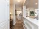 Hallway view leading to kitchen and dining area, showcasing open floor plan and natural light at 108 Leafy Holly Dr, Holly Springs, NC 27540