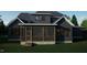 Rear view of a home featuring a screened-in porch with an outdoor living space at 1104 Tobacco Row Ct, Zebulon, NC 27597