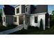Stylish entryway with brick columns, wood accents, and a well-manicured lawn at 1104 Tobacco Row Ct, Zebulon, NC 27597