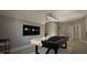 Spacious game room with a pool table, modern lighting, and neutral wall paint at 1104 Tobacco Row Ct, Zebulon, NC 27597