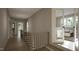 Upstairs hallway with natural hardwood flooring and abundant natural light streaming through windows at 1104 Tobacco Row Ct, Zebulon, NC 27597