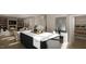 Modern kitchen featuring an island with a marble countertop and stainless steel appliances at 1104 Tobacco Row Ct, Zebulon, NC 27597