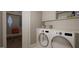 Well-organized laundry room with a washer, dryer, cabinetry, and ample storage space at 1104 Tobacco Row Ct, Zebulon, NC 27597