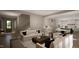 Bright living room featuring plush seating, a staircase, and an open layout into the kitchen at 1104 Tobacco Row Ct, Zebulon, NC 27597