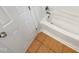 Close up of a bright white bathtub with neutral tile flooring at 11308 Leesville Rd, Raleigh, NC 27613