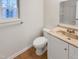 Bathroom features a modern vanity, toilet, and window for natural light at 11308 Leesville Rd, Raleigh, NC 27613