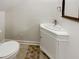 Well-lit bathroom featuring a corner sink, toilet, and neutral flooring at 11308 Leesville Rd, Raleigh, NC 27613