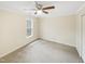 A bright bedroom features a ceiling fan and a window bringing in natural light at 11308 Leesville Rd, Raleigh, NC 27613