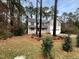 Charming two-story home with a covered porch, surrounded by mature trees and a well-maintained lawn at 11308 Leesville Rd, Raleigh, NC 27613
