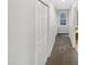 Neutral hallway with closet and view of window and bathroom at 11308 Leesville Rd, Raleigh, NC 27613