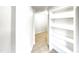 Hallway leading to a room, with neutral tile flooring and convenient shelving at 11308 Leesville Rd, Raleigh, NC 27613