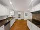 Bright kitchen with white cabinets, stainless steel appliances, and granite countertops at 11308 Leesville Rd, Raleigh, NC 27613