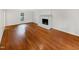 A spacious room with beautiful hardwood floors and a classic brick fireplace at 11308 Leesville Rd, Raleigh, NC 27613