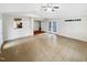 Open living room with tile floors, a ceiling fan, and access to outdoor areas at 11308 Leesville Rd, Raleigh, NC 27613