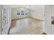 Bright living room with tile flooring, ample natural light, and access to a back door at 11308 Leesville Rd, Raleigh, NC 27613