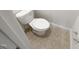 Close-up of a toilet in a bathroom with tile flooring at 11308 Leesville Rd, Raleigh, NC 27613