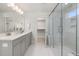 Bright bathroom featuring a glass shower, dual sink vanity, and walk-in closet at 126 Belmont Stakes Ln, Wendell, NC 27591