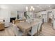 Open concept dining and living room space, with light colored walls and hardwood floors at 126 Belmont Stakes Ln, Wendell, NC 27591