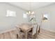 Bright dining room with a rustic dining table, hardwood floors, and a view of the backyard at 126 Belmont Stakes Ln, Wendell, NC 27591