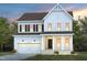 Two-story home with a two car garage, front porch, and manicured lawn at 126 Belmont Stakes Ln, Wendell, NC 27591