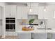Modern kitchen with white cabinets, subway tile backsplash, and stainless appliances at 126 Belmont Stakes Ln, Wendell, NC 27591