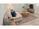 Comfortable living room with a neutral sofa, textured coffee table, and patterned rug at 126 Belmont Stakes Ln, Wendell, NC 27591