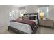 Well-lit main bedroom featuring a plush bed, bedside tables, and stylish decor at 1305 White Verona Way, Knightdale, NC 27545