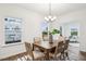 Bright dining room features a modern chandelier, wood table and views of outside at 149 Cribbs Ln, Middlesex, NC 27557