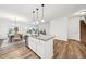 Kitchen island with an undermount sink, light countertops and views to the dining and living spaces at 149 Cribbs Ln, Middlesex, NC 27557