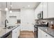Contemporary kitchen with stainless steel appliances, white cabinets, and a gray tile backsplash at 149 Cribbs Ln, Middlesex, NC 27557