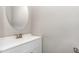 Clean half bathroom with modern vanity and a round mirror at 155 Jade St, Smithfield, NC 27577