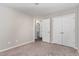 Neutral bedroom featuring an ensuite bathroom access, plus a closet with double doors at 155 Jade St, Smithfield, NC 27577