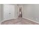 Bedroom featuring neutral carpet and paint, plus closet with double doors at 155 Jade St, Smithfield, NC 27577