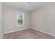 A sunlit bedroom featuring neutral carpet and paint, and a window at 155 Jade St, Smithfield, NC 27577