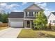 Charming two-story home with a well-maintained lawn, a two-car garage, and lovely landscaping at 155 Jade St, Smithfield, NC 27577