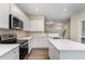 Stylish kitchen featuring quartz countertops, stainless steel appliances, and a kitchen island at 155 Jade St, Smithfield, NC 27577