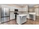 Modern kitchen with stainless steel appliances, quartz countertops, and a center island at 155 Jade St, Smithfield, NC 27577